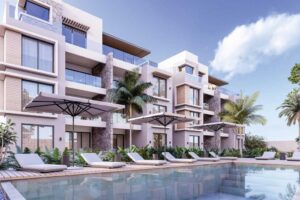 Blick auf den Pool und die von Palmen umgebenen Liegestühle in der Residenz The IVY in Cap Malheureux.