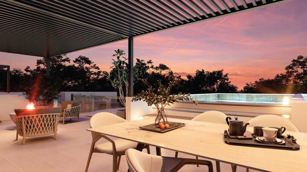 Rooftop terrace with dining area, jacuzzi, and sunset views at The IVY.