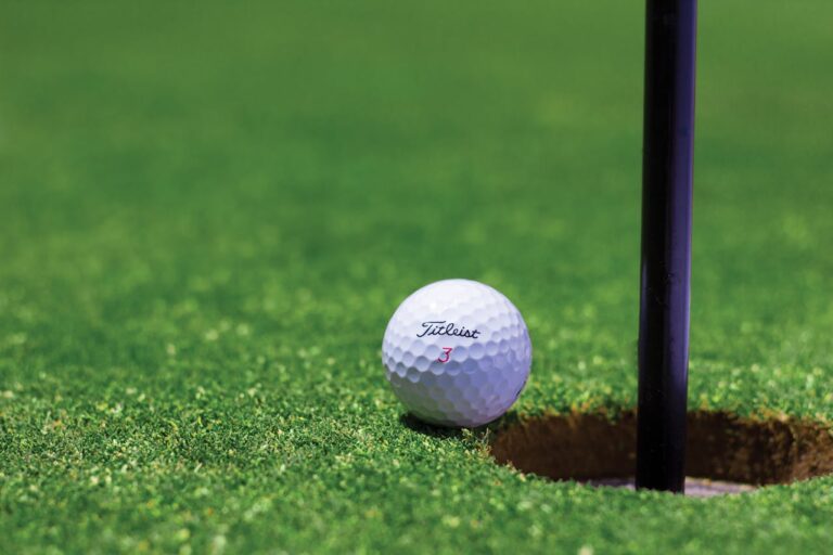 Golf ball at the edge of the hole, The Nine 9-hole course at Azuri, Mauritius