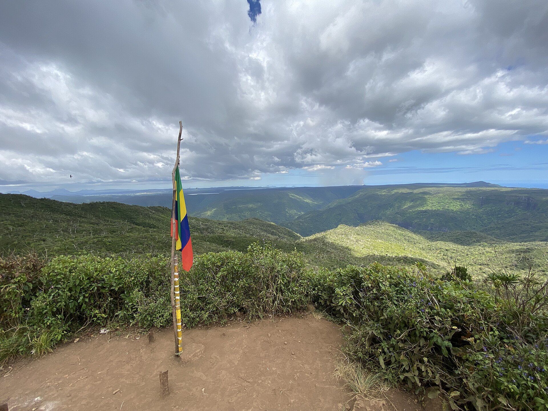 Summit of Piton de la Petite Rivière Noire (Black River Peak) with flag and gorges view – Mauritius