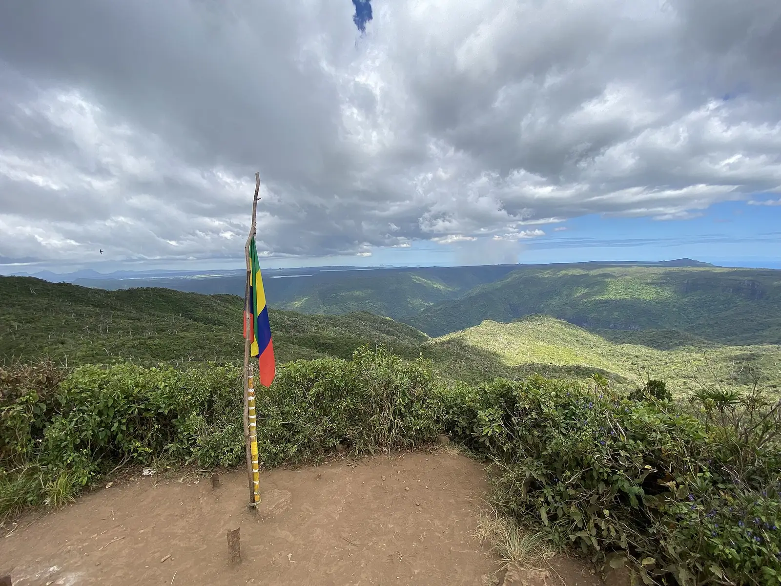 Summit of Black River Peak with flag and view over the gorges, Mauritius